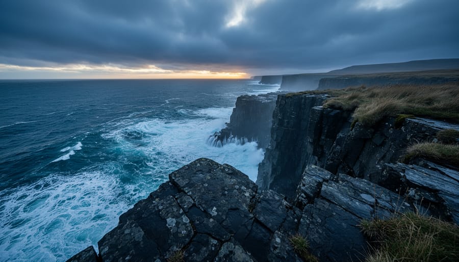 Stormy fjord shoreline at dusk with waves, mist, and a single red cabin light reflecting on wet rocks.